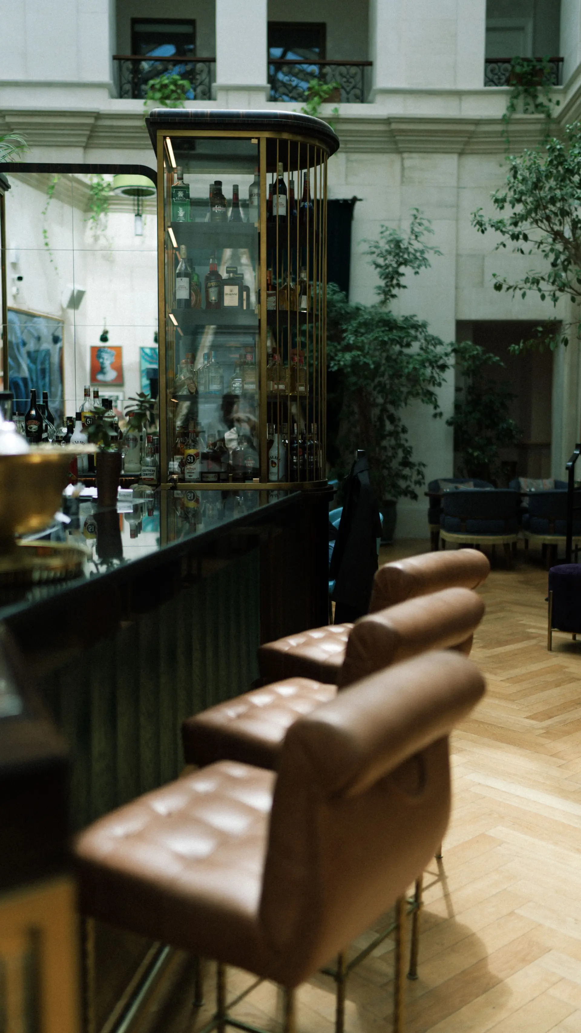 Sophisticated hotel lounge bar with polished leather chairs and warm golden illumination