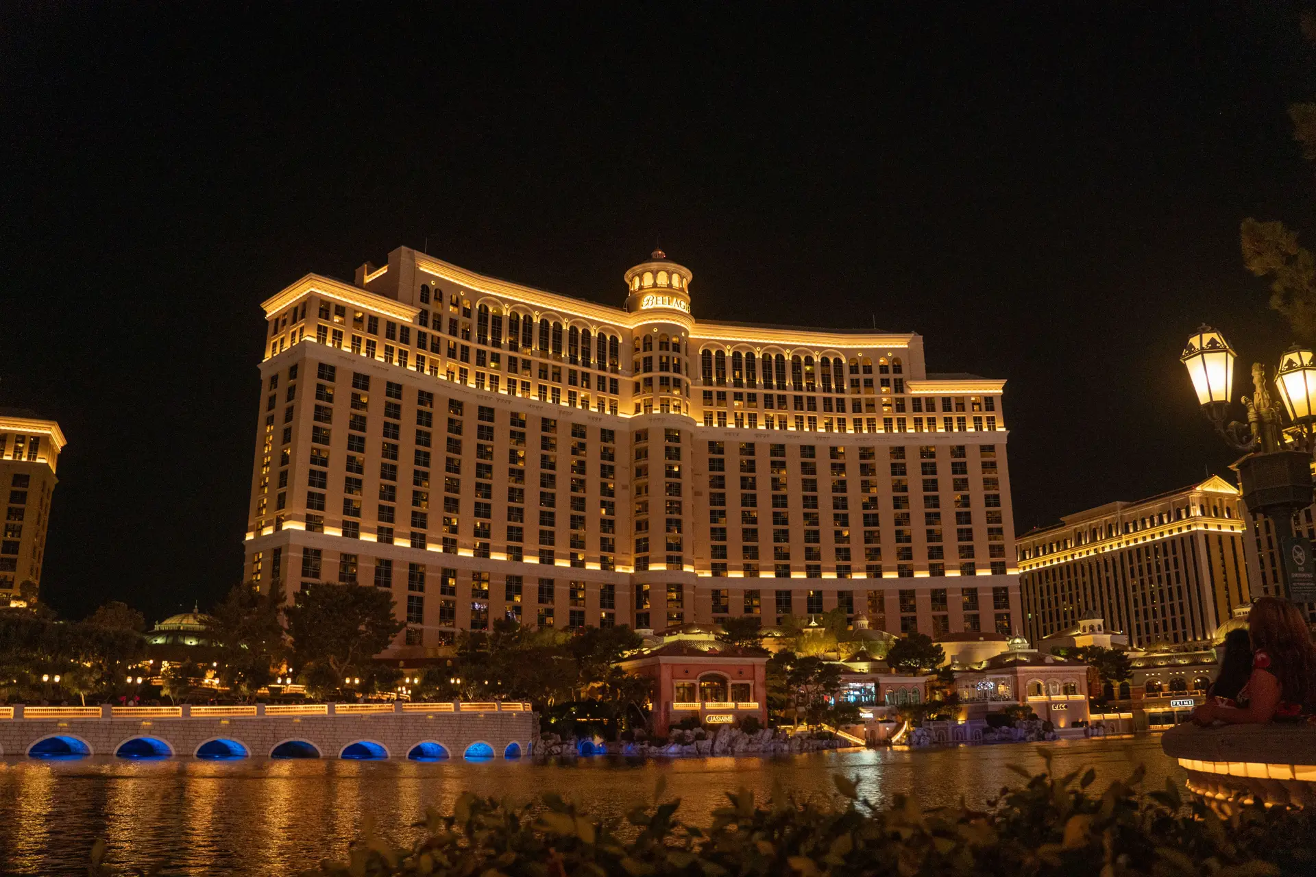 Illuminated resort promenade and luxury hotel tower at night