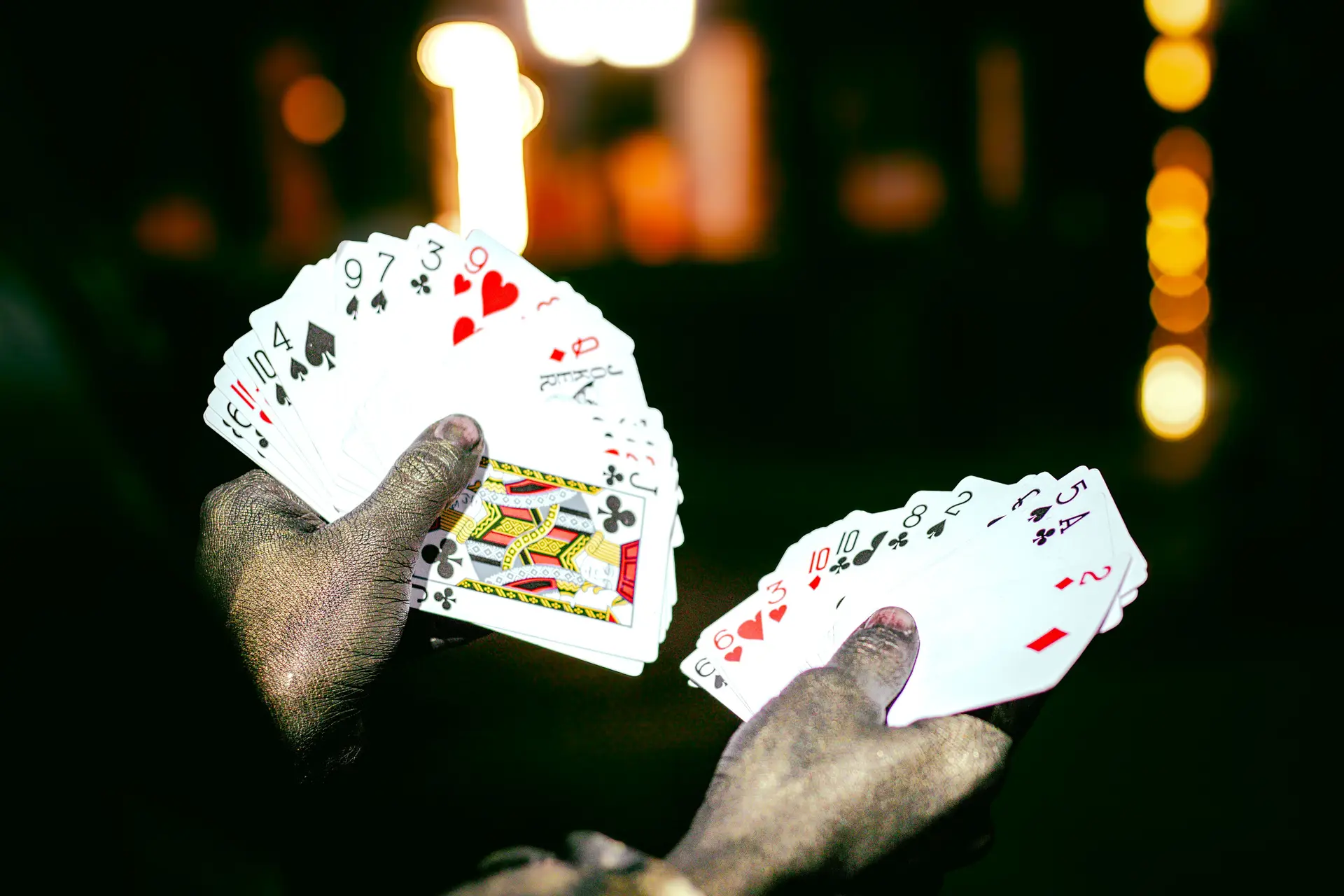 Performer handling playing cards during theatrical stage spectacle