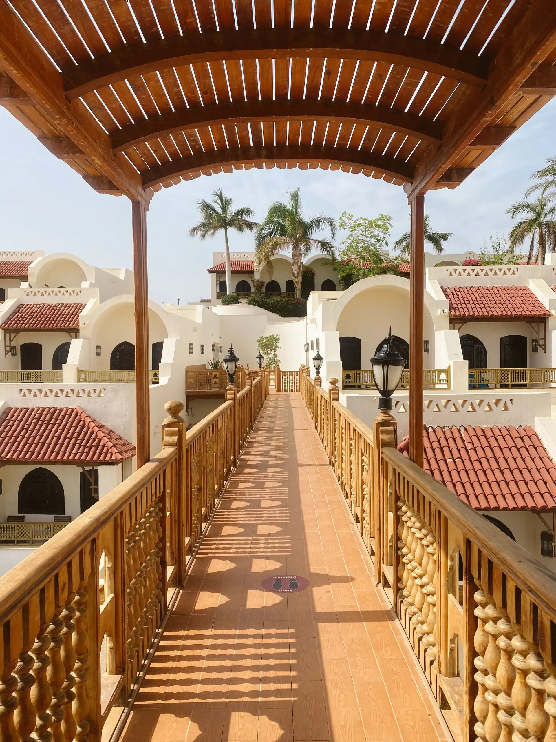 Dusk perspective of luxury resort terrace reflecting warm golden lamps